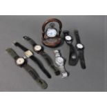Wristwatches and silver pocket watch on watch stand