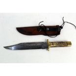 A mid 20th century Bowie knife, having a 10" blade with brass pommel and hilt,