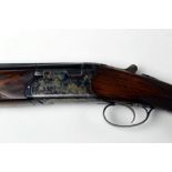 A Webley & Scott 12 bore over/under shotgun, with 28" barrels, half and quarter choke,