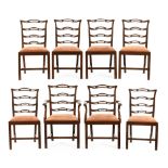 A set of two carver arm and six single George III mahogany ladderback dining chairs with drop in