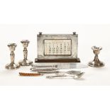 A silver mounted desk calendar, together with a pair of silver candlesticks,