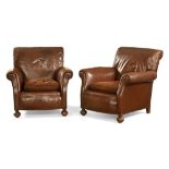 A pair of early 20th century brown leather armchairs,