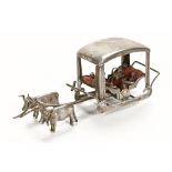 A white metal miniature sleigh,