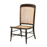 An Edwardian stained oak and wicker bedroom chair,