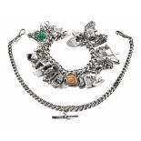 A heavy silver charm bracelet, with padlock and quantity of charms,