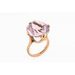 A 9 ct gold ring with amethyst coloured stone. Size N/O, gross weight 8.2 grams.