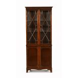 A George III style mahogany cabinet in two sections,