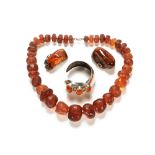 A silver coloured metal and amber bracelet, amber necklace and two silver and amber brooches.