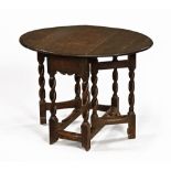 A small antique oak gate leg table, with twin drop flaps, twist legs and low stretchers.