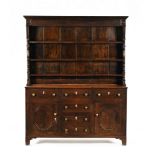 An antique oak dresser with delft rack with applied half round columns,