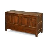 An 18th century oak four panel mule chest, with rectangular hinged top and square feet.