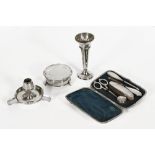 A George V silver mounted manicure set, with scissors, jar and cover, nail buffer etc.