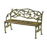 A Victorian green painted branch form cast iron garden seat, with slatted seating area.