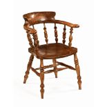 An ash and elm office armchair, with bowed top rail,