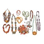 A quantity of ethnic necklaces, including coral, amber etc, some requiring re-stringing.