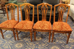 Four pine dining chairs with upholstered seats