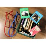 Two saddle racks and box of books on horse keeping