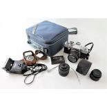 A Praktica L2 camera with Pentacon 50mm lens in camera bag with accessories