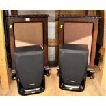 Two Panasonic speakers and a pair of matching wooden speaker cabinets