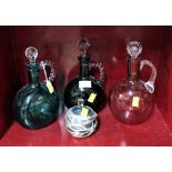 Three coloured glass decanters and a scent bottle