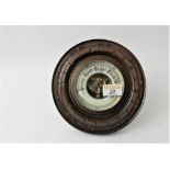 Barometer in round wooden surround,