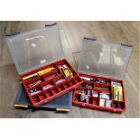 Three plastic storage boxes of precision tools