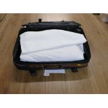 Suitcase containing a quantity of linen sheets