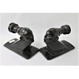 Two ethnic ebonised wooden bookends