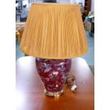 Oriental style lamp with bulbous red base and cream shade,