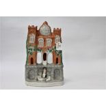 Staffordshire flat back figure formed as a house with clock tower