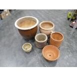 Five terracotta garden plant pots