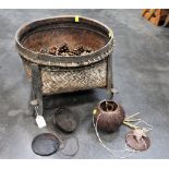 Willow log basket on raised legs containing giant pinecones