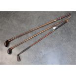 Three vintage golf clubs