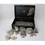 Metal cash tin containing shillings and other coins