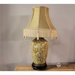 Bulbous ceramic lamp base with gold tasselled shade,