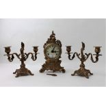 Brass German mantel clock with pair of brass candlesticks