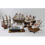 Four models of sailing ships and ship in bottle