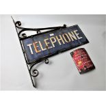Two vintage metal signs, one wall mounted "Telephone",