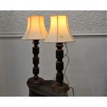 Two heavily carved wooden lamps,