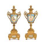 A pair of French Sevres style porcelain urns, with gilt bronze mounts,