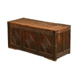 An 18th century oak three panelled coffer, with diamond carvings to front and raised on stile feet.