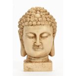 An Oriental marble Buddha head. Height 15 cm.