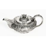 A George IV Irish silver teapot, repousse with foliate scroll work, Dublin mark 1826,