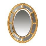 A late 20th century oval gilt framed mirror, with bevelled edge. Height 108 cm, width 83 cm.