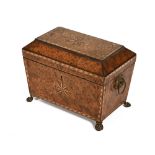 A Georgian burr yew tea caddy, with two interior compartments and raised on pressed metal feet.
