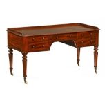 A large Victorian mahogany dressing table or desk, with rounded corners and shallow gallery,