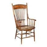 An American oak kitchen armchair, with spindled arm supports, turned legs and stretchers.
