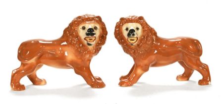 A pair of late 19th century Staffordshire pottery lions, of traditional Victorian design,