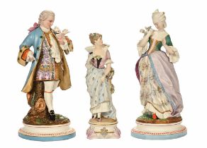 A pair of bisque figures, modelled as period lady and gentleman holding doves.