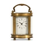 A brass French carriage clock of small form, oval in plan, timepiece only.
